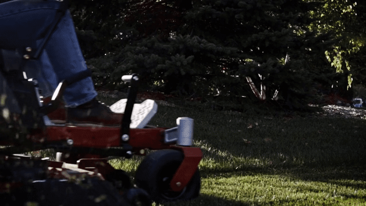 The TORO 42" TimeCutter® Zero Turn Mower in action, effortlessly maneuvering around trees and obstacles with its 42" stamped steel deck and 22 HP Briggs & Stratton engine. Highlighting its wide 18" rear tires, handcrafted seat, step-through front end, and Smart Speed® controls. Perfect for homeowners with up to 2 acres of lawn.