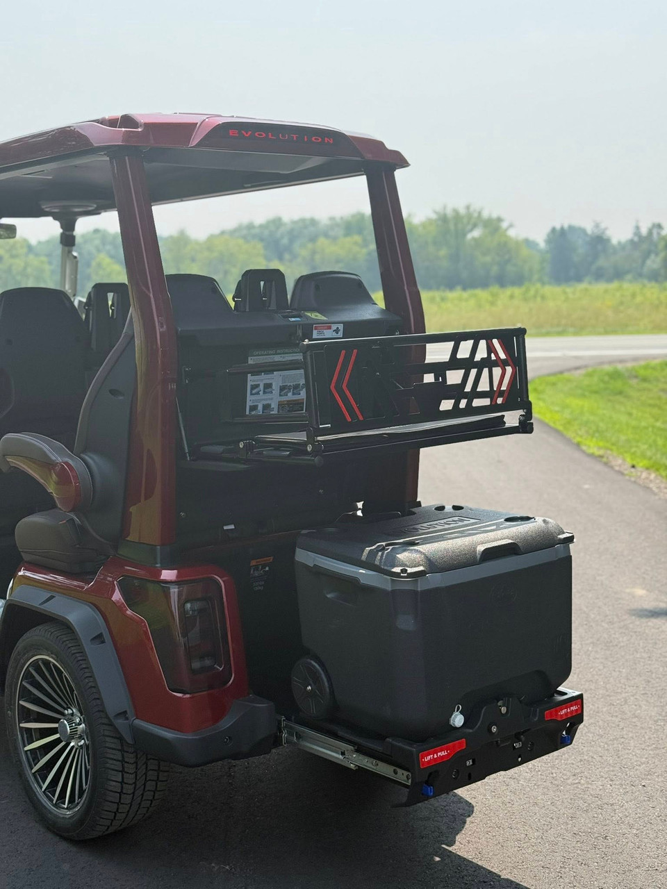 Evolution D-MAX GT4 luxury electric golf cart with forward-facing design, black automotive-grade seats, 10.1-inch touchscreen with CarPlay, 24-speaker audio system, LED lighting, and aluminum wheels, built for performance and style.