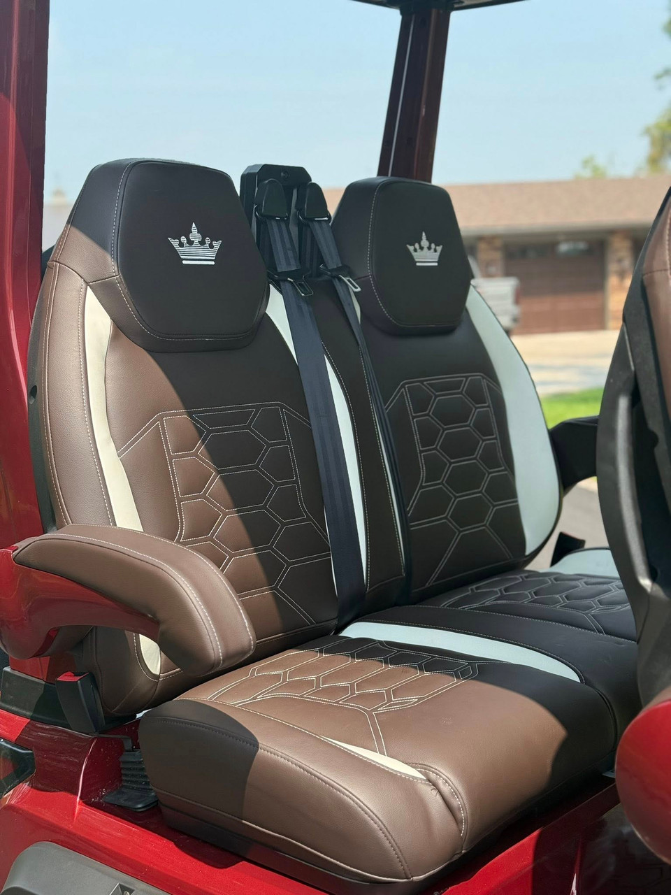 Evolution D-MAX GT4 luxury electric golf cart with forward-facing design, black automotive-grade seats, 10.1-inch touchscreen with CarPlay, 24-speaker audio system, LED lighting, and aluminum wheels, built for performance and style.