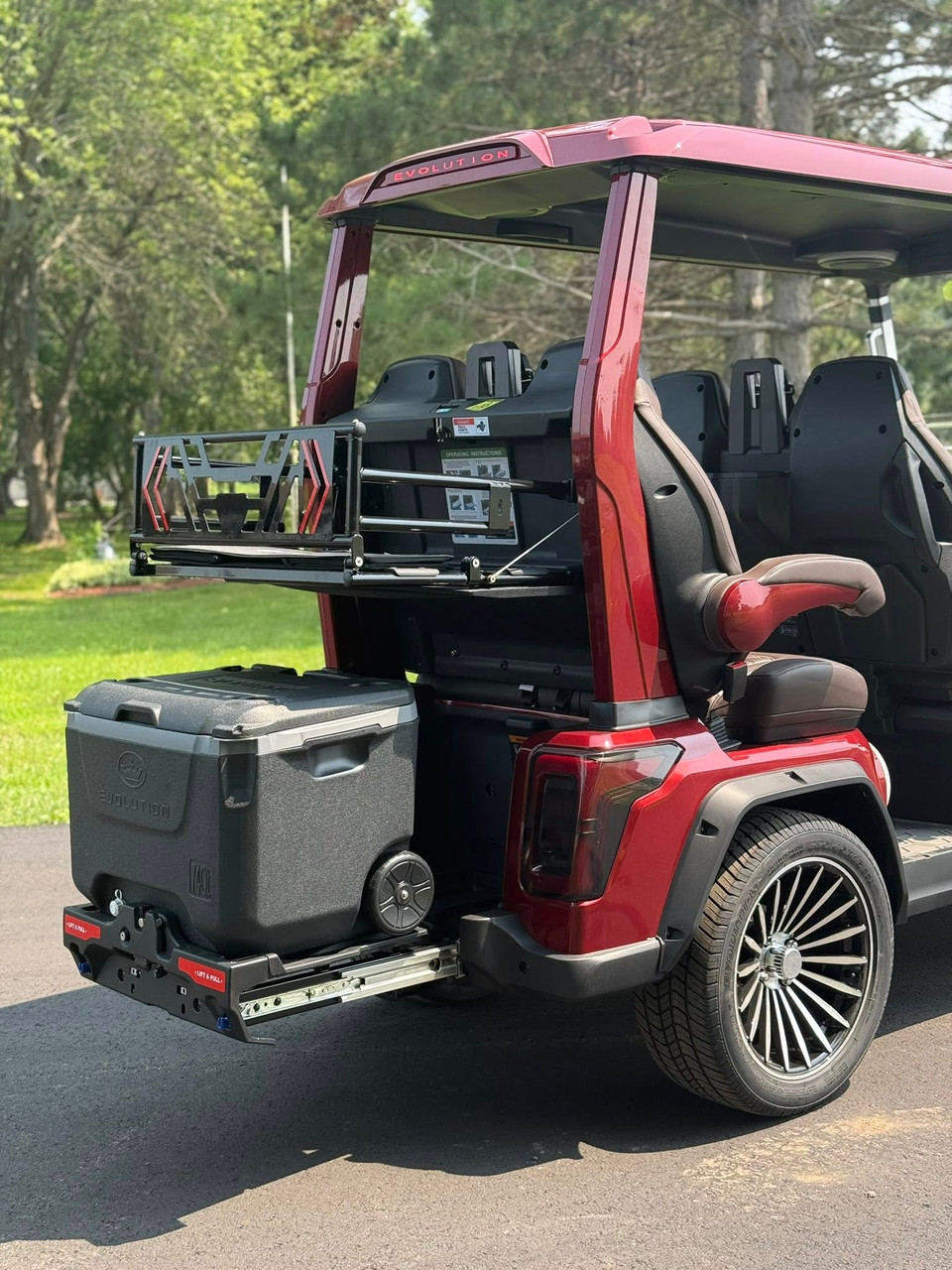 Evolution D-MAX GT4 luxury electric golf cart with forward-facing design, black automotive-grade seats, 10.1-inch touchscreen with CarPlay, 24-speaker audio system, LED lighting, and aluminum wheels, built for performance and style.