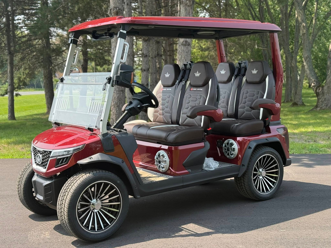 Evolution D-MAX GT4 luxury electric golf cart with forward-facing design, black automotive-grade seats, 10.1-inch touchscreen with CarPlay, 24-speaker audio system, LED lighting, and aluminum wheels, built for performance and style.