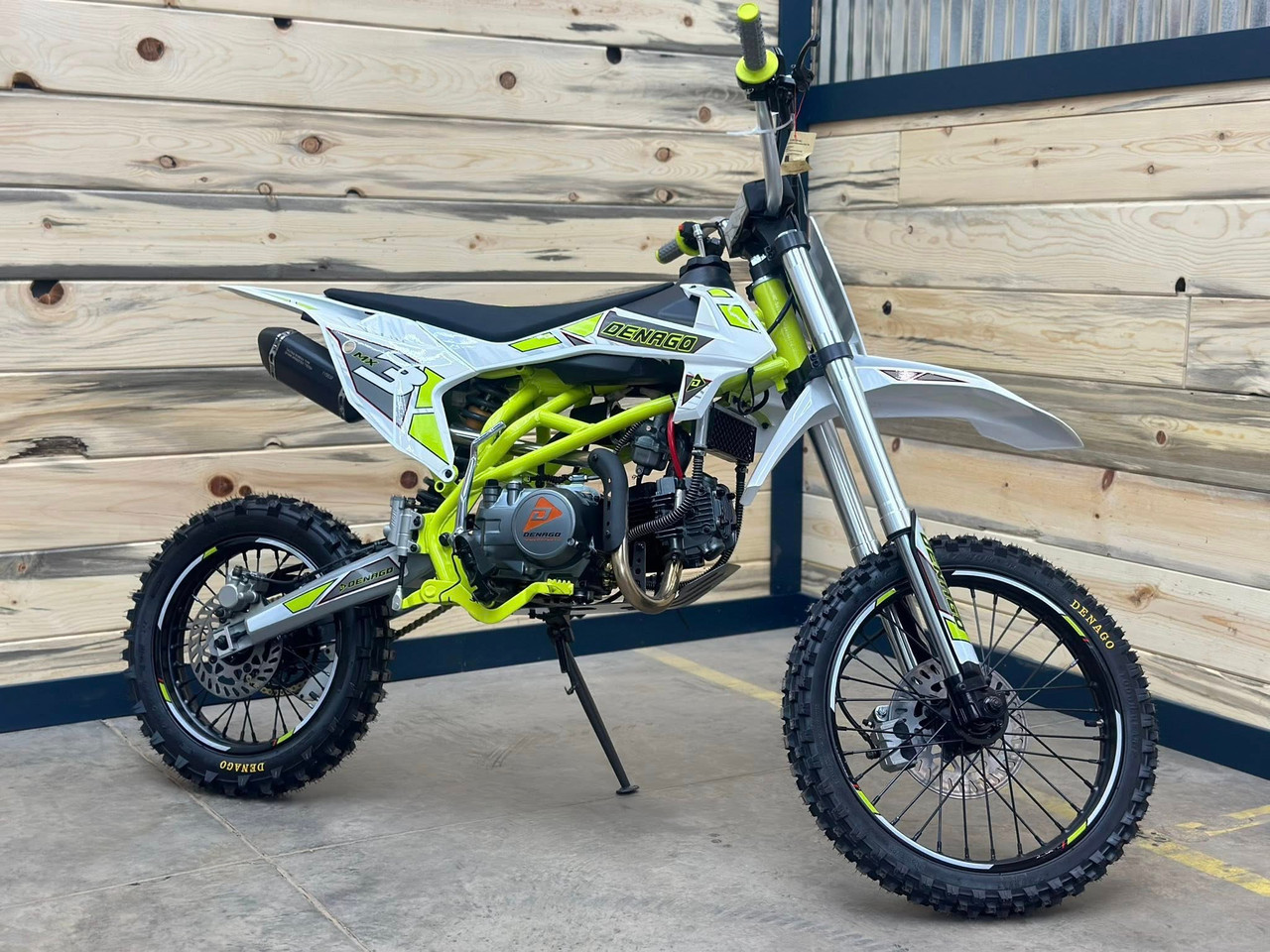"The Denago MX3 Lime Edition pit bike features a 140cc engine with 4-speed transmission, hydraulic disc brakes, and adjustable suspension. Shown with vibrant lime green accents on CNC components, black powder-coated wheels, and aggressive knobby tires, this performance bike offers inverted forks, folding levers, and stainless exhaust. Perfect for serious trail riding with 14.5" ground clearance." "The Denago MX3 Lime Edition pit bike features a 140cc engine with 4-speed transmission, hydraulic disc brakes, and adjustable suspension. Shown with vibrant lime green accents on CNC components, black powder-coated wheels, and aggressive knobby tires, this performance bike offers inverted forks, folding levers, and stainless exhaust. Perfect for serious trail riding with 14.5" ground clearance."
