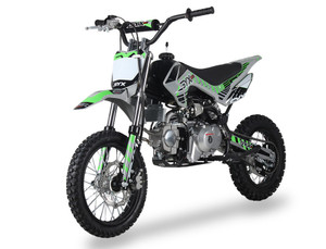 Syx Moto PAD125-1S 125cc semi-automatic pit bike featuring a black steel frame, aggressive new plastics design, and knobby off-road tires. The bike is shown in an off-road setting, highlighting its front hydraulic disc brake, remote oil cooler, and dual start system. The 14-inch front wheel and 12-inch rear wheel with heavy-duty spokes are clearly visible.