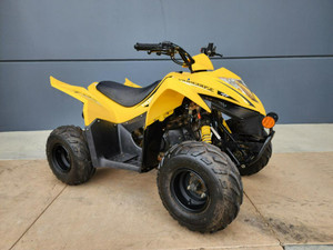 KYMCO Mongoose 70S Youth ATV in action, highlighting its sporty matte black wheels, ergonomic seat, and compact design. The ATV is shown navigating a dirt trail, emphasizing its off-road capabilities and youth-friendly features such as the single headlight, rear grab bar, and adjustable suspension. The safety flag mounted on the rear adds a touch of visibility, while the tether cord is visible near the handlebars, underscoring the ATV's commitment to safety. KYMCO Mongoose 70S Youth ATV in action, highlighting its sporty matte black wheels, ergonomic seat, and compact design. The ATV is shown navigating a dirt trail, emphasizing its off-road capabilities and youth-friendly features such as the single headlight, rear grab bar, and adjustable suspension. The safety flag mounted on the rear adds a touch of visibility, while the tether cord is visible near the handlebars, underscoring the ATV's commitment to safety.