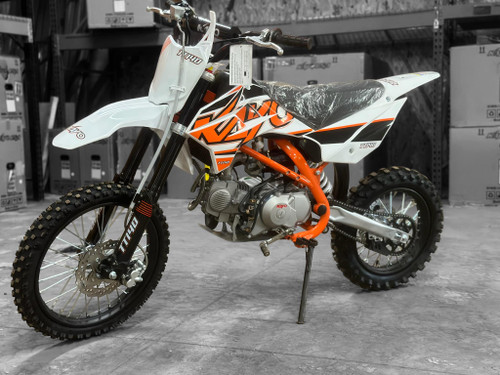 The image showcases the Kayo TT140 140cc Pit Bike, a high-performance off-road machine designed for riders who demand power and precision. The bike features a sleek and aggressive design with a 33.6-inch seat height, making it suitable for taller riders. The 140cc 4-stroke engine and electric/kick start system are highlighted, emphasizing the bike's power and ease of use. The inverted front forks and single rear shock are prominently displayed, showcasing the bike's advanced suspension system. The front and rear disc brakes are visible, highlighting the bike's safety features. The 17-inch front tire and 14-inch rear tire provide excellent traction and stability, while the low tack seat cover adds comfort and grip. The 11.4-inch ground clearance allows the bike to tackle rough terrains with ease. Overall, the image captures the essence of a powerful, high-performing, and versatile pit bike ready for any off-road adventure. The image showcases the Kayo TT140 140cc Pit Bike, a high-performance off-road machine designed for riders who demand power and precision. The bike features a sleek and aggressive design with a 33.6-inch seat height, making it suitable for taller riders. The 140cc 4-stroke engine and electric/kick start system are highlighted, emphasizing the bike's power and ease of use. The inverted front forks and single rear shock are prominently displayed, showcasing the bike's advanced suspension system. The front and rear disc brakes are visible, highlighting the bike's safety features. The 17-inch front tire and 14-inch rear tire provide excellent traction and stability, while the low tack seat cover adds comfort and grip. The 11.4-inch ground clearance allows the bike to tackle rough terrains with ease. Overall, the image captures the essence of a powerful, high-performing, and versatile pit bike ready for any off-road adventure.