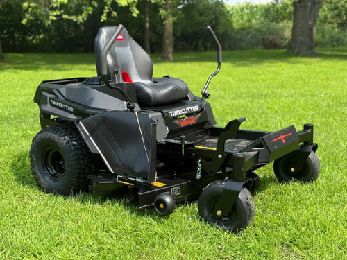 2025 Toro 54" Timecutter Max Havoc Zero Turn Mower in action, highlighting its heavy-duty IronForged® deck, gaming-style seat, and beefy hybrid-tread tires. The mower’s aggressive design and bold paint job exude power and durability, while the automotive-style fuel fill and spray-blocking fenders emphasize its user-friendly features. The four-point deck hanging system and integrated drain hose are visible, showcasing the mower’s ease of use and maintenance. This image captures the essence of a professional-grade machine designed for residential lawn care excellence.