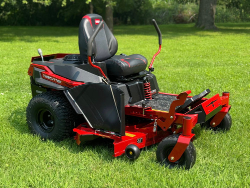 The image showcases the Toro TimeCutter MAX with MyRIDE® Suspension, a zero-turn mower designed for residential lawn care. The mower features a 54-inch IronForged® steel deck, a gaming-style seat, and hybrid-tread rear tires for maximum traction. The MyRIDE® Suspension System is prominently highlighted, emphasizing its ability to provide a smooth, comfortable ride over rough terrain. The image also highlights the spray-blocking fenders, automotive-style fuel fill, and integrated drain hose, showcasing the mower's user-friendly and maintenance-friendly features.