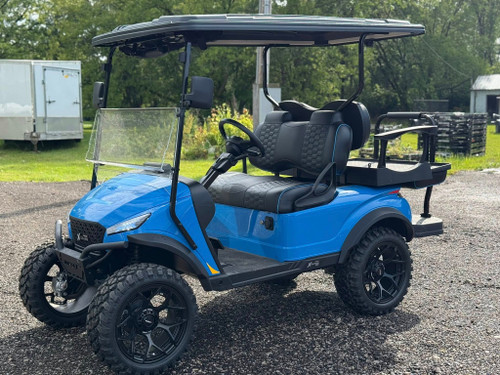 The 2024 MadJax X Series X4 Golf Cart features a sleek, modern design with a bold front grille, LED lighting, and vibrant high-gloss color options. The luxurious interior includes premium seating, USB ports, cup holders, and a folding windshield. With a 3" lift, hydraulic disc brakes, and a powerful 5KW motor, this cart is built for style and performance.