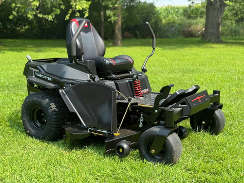 The TORO 60" TimeCutter® MyRIDE® MAX Zero Turn Mower gliding effortlessly across a lush lawn, showcasing its 60" IronForged deck, 24 HP Kohler engine, and patented MyRIDE® Suspension System. Highlighting the 20" hybrid-tread rear tires, automotive-style fuel fill, and ergonomic gaming seat—perfect for homeowners who demand pro-level comfort and performance.