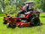I-Beam Front End Close-Up:
A close-up shot of the TITAN’s commercial-style I-beam front end, showcasing its rugged, heavy-duty construction. The thick steel beams are built to withstand extreme conditions, ensuring unmatched durability and strength for tackling the toughest mowing jobs.

MyRIDE® Suspension System:
A detailed image of the patented MyRIDE® Suspension System, featuring a large spring coil isolated from the mower frame. This innovative design absorbs shocks and vibrations, providing a smooth, comfortable ride even on rough terrain.

IronForged® Deck:
A close-up of the 54-inch IronForged® deck, highlighting its heavy-duty 10-gauge steel construction. The reinforced belts, beefy leading edge, and massive spindles are visible, showcasing the deck’s ability to handle rocks, roots, and thick grass without flinching.

Rear Tires:
A side view of the TITAN’s 22-inch rear tires, emphasizing their aggressive tread pattern. These massive tires are designed for maximum traction, ensuring the mower can power through steep hills, wet grass, and uneven terrain with ease.

Front Caster Tires:
A close-up of the 13-inch treaded front caster tires, showcasing their rugged design. The treads add stability and grip, while the pneumatic construction ensures a smooth ride over obstacles.

Gaming-Style Seat:
A detailed shot of the 20-inch gaming-style seat, featuring black upholstery with red side stripes. The ergonomic design provides exceptional lumbar support and comfort, making long mowing sessions feel effortless.

Rubber Discharge Chute:
A close-up of the commercial-style rubber discharge chute, highlighting its flexibility and durability. The chute bends without breaking, allowing for precise trimming close to landscaping features without causing damage.

MyToro App Icon:
A digital image of the MyToro App icon, displayed on a smartphone screen. The app provides easy access to manuals, how-to videos, service reminders, and more, making it a must-have tool for TITAN owners.

Full Machine Overview:
A wide-angle shot of the 2024 Toro TITAN 54" MyRIDE Zero Turn Mower in action, cutting through a lush, green lawn. The mower’s sleek design, reinforced bullnose bumper, and aggressive stance are on full display, showcasing its power and dominance.

Cast Aluminum Stomp Pad:
A close-up of the cast aluminum stomp pad, located near the mower’s step-up area. The textured surface provides a secure grip for scraping boots and stepping onto the machine, adding both functionality and durability.

Height-of-Cut Adjustment:
A detailed image of the drop pin height-of-cut system, showing the easy-to-use adjustment mechanism. This professional-grade feature allows for quick and precise height adjustments, ensuring a perfect cut every time.

Engine Close-Up:
A close-up of the 26 HP Kohler KT745 engine, highlighting its robust design and air-cooled system. The engine’s power and reliability are evident, making it the heart of the TITAN’s unmatched performance.