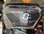 The image features the Denago E-Hawk 6 ATV, a sleek and modern electric ATV designed for kids aged 6 and up. The ATV showcases a bold black finish with multicolored LED lights, giving it a stylish and futuristic look. The rugged all-terrain tires (AT 16 x 8-7) and double A-arm front suspension highlight its capability to handle various terrains, from dirt trails to grassy fields. The handlebar-mounted controls, including the push-button gear selector and keyed ignition, are clearly visible, emphasizing the ATV's user-friendly design. The compact dimensions (51" x 31" x 32.5") and low seat height (23.5") make it perfectly sized for young riders, while the 48V removable lithium-ion battery and 1600W brushless electric motor underscore its eco-friendly and high-performance features. Safety elements like dual hydraulic disk brakes and an anti-theft alarm are subtly integrated into the design. This image captures the essence of the E-Hawk 6 ATV as a safe, fun, and technologically advanced electric vehicle for kids.