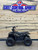 The image features the Denago E-Hawk 6 ATV, a sleek and modern electric ATV designed for kids aged 6 and up. The ATV showcases a bold black finish with multicolored LED lights, giving it a stylish and futuristic look. The rugged all-terrain tires (AT 16 x 8-7) and double A-arm front suspension highlight its capability to handle various terrains, from dirt trails to grassy fields. The handlebar-mounted controls, including the push-button gear selector and keyed ignition, are clearly visible, emphasizing the ATV's user-friendly design. The compact dimensions (51" x 31" x 32.5") and low seat height (23.5") make it perfectly sized for young riders, while the 48V removable lithium-ion battery and 1600W brushless electric motor underscore its eco-friendly and high-performance features. Safety elements like dual hydraulic disk brakes and an anti-theft alarm are subtly integrated into the design. This image captures the essence of the E-Hawk 6 ATV as a safe, fun, and technologically advanced electric vehicle for kids.