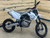 The image showcases the SSR XD150 Dirt Bike in a rugged, off-road setting, highlighting its powerful design and advanced features. The dirt bike features a white color option, inverted hydraulic front forks, and aluminum alloy wheels with 70/100-17 front tires and 90/100-14 rear tires. The dual disc brakes are prominently displayed, emphasizing the bike's safety and control features. The rebound-adjustable rear shock and cast steel frame are visible, showcasing the bike's durability and stability. This image perfectly captures the SSR XD150's blend of performance, safety, and style, making it an ideal choice for off-road enthusiasts.