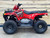 Odes Angler 120cc EFI Youth ATV in a vibrant red and black color scheme, highlighting its sleek and rugged design. The ATV is positioned on a dirt trail, emphasizing its off-road capabilities. Key features such as the front and rear racks, durable wheels, and ergonomic seat are clearly visible, making it evident that this ATV is built for adventure. The image also highlights the ATV's compact size, making it ideal for young riders.