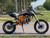Denago MX3 Orange Edition 140cc Pit Bike with high-performance hydraulic disc brakes, inverted front fork suspension, stainless-steel exhaust, and sleek orange graphics for a striking off-road look.