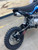 SSR SR125ME 125cc Pit Bike – Black & Blue Edition, featuring aggressive styling, 14" front and 12" rear knobby tires, inverted front forks, manual 4-speed transmission, and both electric and kick start. Highlighted in bold black and electric blue color scheme with disc brakes and a high-clearance steel frame for off-road terrain.