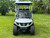Evolution D-MAX GT4 luxury electric golf cart with forward-facing design, black automotive-grade seats, 10.1-inch touchscreen with CarPlay, 24-speaker audio system, LED lighting, and aluminum wheels, built for performance and style.