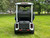Evolution D-MAX GT4 luxury electric golf cart with forward-facing design, black automotive-grade seats, 10.1-inch touchscreen with CarPlay, 24-speaker audio system, LED lighting, and aluminum wheels, built for performance and style.