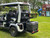 Evolution D-MAX GT4 luxury electric golf cart with forward-facing design, black automotive-grade seats, 10.1-inch touchscreen with CarPlay, 24-speaker audio system, LED lighting, and aluminum wheels, built for performance and style.