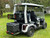 Evolution D-MAX GT4 luxury electric golf cart with forward-facing design, black automotive-grade seats, 10.1-inch touchscreen with CarPlay, 24-speaker audio system, LED lighting, and aluminum wheels, built for performance and style.