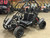 The image showcases the Hammerhead by Polaris MudHead 208R, a versatile and high-performing go-kart designed for young adventurers aged 10 and up. The go-kart features a sleek and durable design with a brush guard at the front for added protection. The 208cc LCT electric-start engine is highlighted, emphasizing the go-kart's power and ease of use. The dual LED headlights and canopy top are visible, showcasing the go-kart's stylish and functional design. The 16 x 6 – 8-inch front tires and 16 x 7 – 8-inch rear tires provide excellent traction and stability, while the rear hydraulic disc brake ensures safe and reliable stopping power. The three-point harness seatbelt adds an extra layer of safety, making it a perfect choice for young riders. Overall, the image captures the essence of a safe, durable, and fun go-kart ready for endless adventures.