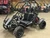 The image showcases the Hammerhead by Polaris MudHead 208R, a versatile and high-performing go-kart designed for young adventurers aged 10 and up. The go-kart features a sleek and durable design with a brush guard at the front for added protection. The 208cc LCT electric-start engine is highlighted, emphasizing the go-kart's power and ease of use. The dual LED headlights and canopy top are visible, showcasing the go-kart's stylish and functional design. The 16 x 6 – 8-inch front tires and 16 x 7 – 8-inch rear tires provide excellent traction and stability, while the rear hydraulic disc brake ensures safe and reliable stopping power. The three-point harness seatbelt adds an extra layer of safety, making it a perfect choice for young riders. Overall, the image captures the essence of a safe, durable, and fun go-kart ready for endless adventures.