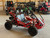 The image showcases the Hammerhead by Polaris MudHead 208R, a versatile and high-performing go-kart designed for young adventurers aged 10 and up. The go-kart features a sleek and durable design with a brush guard at the front for added protection. The 208cc LCT electric-start engine is highlighted, emphasizing the go-kart's power and ease of use. The dual LED headlights and canopy top are visible, showcasing the go-kart's stylish and functional design. The 16 x 6 – 8-inch front tires and 16 x 7 – 8-inch rear tires provide excellent traction and stability, while the rear hydraulic disc brake ensures safe and reliable stopping power. The three-point harness seatbelt adds an extra layer of safety, making it a perfect choice for young riders. Overall, the image captures the essence of a safe, durable, and fun go-kart ready for endless adventures.