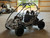 The image showcases the Hammerhead by Polaris MudHead 208R, a versatile and high-performing go-kart designed for young adventurers aged 10 and up. The go-kart features a sleek and durable design with a brush guard at the front for added protection. The 208cc LCT electric-start engine is highlighted, emphasizing the go-kart's power and ease of use. The dual LED headlights and canopy top are visible, showcasing the go-kart's stylish and functional design. The 16 x 6 – 8-inch front tires and 16 x 7 – 8-inch rear tires provide excellent traction and stability, while the rear hydraulic disc brake ensures safe and reliable stopping power. The three-point harness seatbelt adds an extra layer of safety, making it a perfect choice for young riders. Overall, the image captures the essence of a safe, durable, and fun go-kart ready for endless adventures.