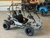 The image showcases the Hammerhead by Polaris MudHead 208R, a versatile and high-performing go-kart designed for young adventurers aged 10 and up. The go-kart features a sleek and durable design with a brush guard at the front for added protection. The 208cc LCT electric-start engine is highlighted, emphasizing the go-kart's power and ease of use. The dual LED headlights and canopy top are visible, showcasing the go-kart's stylish and functional design. The 16 x 6 – 8-inch front tires and 16 x 7 – 8-inch rear tires provide excellent traction and stability, while the rear hydraulic disc brake ensures safe and reliable stopping power. The three-point harness seatbelt adds an extra layer of safety, making it a perfect choice for young riders. Overall, the image captures the essence of a safe, durable, and fun go-kart ready for endless adventures.