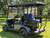 The 2025 MadJax E Series Golf Cart boasts a sleek, modern design with LED lighting, a 7" LCD display, and stylish GTW wheels. The spacious interior includes dual USB ports, comfortable seating, and smart storage. Powered by a zero-maintenance Eco Lithium battery, this cart delivers extended range and unbeatable value.