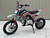 Syx Moto PAD125-1S 125cc semi-automatic pit bike featuring a black steel frame, aggressive new plastics design, and knobby off-road tires. The bike is shown in an off-road setting, highlighting its front hydraulic disc brake, remote oil cooler, and dual start system. The 14-inch front wheel and 12-inch rear wheel with heavy-duty spokes are clearly visible. Syx Moto PAD125-1S 125cc semi-automatic pit bike featuring a black steel frame, aggressive new plastics design, and knobby off-road tires. The bike is shown in an off-road setting, highlighting its front hydraulic disc brake, remote oil cooler, and dual start system. The 14-inch front wheel and 12-inch rear wheel with heavy-duty spokes are clearly visible.