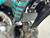 The image showcases the SYX MotoPro WHIP PAD125-3 125cc Pit Bike in one of its three available color options. The bike features a sleek design with upgraded graphics and plastics, highlighting its modern and aggressive look. The anodized hydraulic front fork and coil spring rear shock absorber are visible, emphasizing the bike's advanced suspension system. The heavy-duty black steel rims with off-road tires and hydraulic disc brakes are prominently displayed, showcasing the bike's durability and safety features. The handlebar with a built-in hour meter and the SY-Forged triple clamp add to the bike's premium feel. Overall, the image captures the essence of a high-performance, stylish, and durable pit bike ready for any off-road adventure.