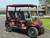 Evolution D-MAX GT4 luxury electric golf cart with forward-facing design, black automotive-grade seats, 10.1-inch touchscreen with CarPlay, 24-speaker audio system, LED lighting, and aluminum wheels, built for performance and style.