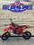 Denago MX3 Red Edition 140cc Pit Bike with bold red graphics, black powder-coated wheels, stainless steel exhaust, gold drive chain, and CNC anodized components for trail and off-road riding.