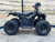 The image features the Denago E-Hawk 6 ATV, a sleek and modern electric ATV designed for kids aged 6 and up. The ATV showcases a bold black finish with multicolored LED lights, giving it a stylish and futuristic look. The rugged all-terrain tires (AT 16 x 8-7) and double A-arm front suspension highlight its capability to handle various terrains, from dirt trails to grassy fields. The handlebar-mounted controls, including the push-button gear selector and keyed ignition, are clearly visible, emphasizing the ATV's user-friendly design. The compact dimensions (51" x 31" x 32.5") and low seat height (23.5") make it perfectly sized for young riders, while the 48V removable lithium-ion battery and 1600W brushless electric motor underscore its eco-friendly and high-performance features. Safety elements like dual hydraulic disk brakes and an anti-theft alarm are subtly integrated into the design. This image captures the essence of the E-Hawk 6 ATV as a safe, fun, and technologically advanced electric vehicle for kids.
