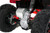 The image features the Denago E-Hawk 6 ATV, a sleek and modern electric ATV designed for kids aged 6 and up. The ATV showcases a bold black finish with multicolored LED lights, giving it a stylish and futuristic look. The rugged all-terrain tires (AT 16 x 8-7) and double A-arm front suspension highlight its capability to handle various terrains, from dirt trails to grassy fields. The handlebar-mounted controls, including the push-button gear selector and keyed ignition, are clearly visible, emphasizing the ATV's user-friendly design. The compact dimensions (51" x 31" x 32.5") and low seat height (23.5") make it perfectly sized for young riders, while the 48V removable lithium-ion battery and 1600W brushless electric motor underscore its eco-friendly and high-performance features. Safety elements like dual hydraulic disk brakes and an anti-theft alarm are subtly integrated into the design. This image captures the essence of the E-Hawk 6 ATV as a safe, fun, and technologically advanced electric vehicle for kids.