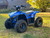 The image features the Denago E-Hawk 6 ATV, a sleek and modern electric ATV designed for kids aged 6 and up. The ATV showcases a bold black finish with multicolored LED lights, giving it a stylish and futuristic look. The rugged all-terrain tires (AT 16 x 8-7) and double A-arm front suspension highlight its capability to handle various terrains, from dirt trails to grassy fields. The handlebar-mounted controls, including the push-button gear selector and keyed ignition, are clearly visible, emphasizing the ATV's user-friendly design. The compact dimensions (51" x 31" x 32.5") and low seat height (23.5") make it perfectly sized for young riders, while the 48V removable lithium-ion battery and 1600W brushless electric motor underscore its eco-friendly and high-performance features. Safety elements like dual hydraulic disk brakes and an anti-theft alarm are subtly integrated into the design. This image captures the essence of the E-Hawk 6 ATV as a safe, fun, and technologically advanced electric vehicle for kids.