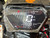 The image features the Denago E-Hawk 6 ATV, a sleek and modern electric ATV designed for kids aged 6 and up. The ATV showcases a bold black finish with multicolored LED lights, giving it a stylish and futuristic look. The rugged all-terrain tires (AT 16 x 8-7) and double A-arm front suspension highlight its capability to handle various terrains, from dirt trails to grassy fields. The handlebar-mounted controls, including the push-button gear selector and keyed ignition, are clearly visible, emphasizing the ATV's user-friendly design. The compact dimensions (51" x 31" x 32.5") and low seat height (23.5") make it perfectly sized for young riders, while the 48V removable lithium-ion battery and 1600W brushless electric motor underscore its eco-friendly and high-performance features. Safety elements like dual hydraulic disk brakes and an anti-theft alarm are subtly integrated into the design. This image captures the essence of the E-Hawk 6 ATV as a safe, fun, and technologically advanced electric vehicle for kids.