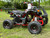 The image showcases the Tao Motor D125 Youth ATV in a dynamic, off-road setting, highlighting its sleek design and vibrant color options. The ATV features a powder-coated frame, color-matched components, and new decal designs, giving it a modern and stylish appearance. The LED daytime running lights are prominently displayed, emphasizing safety and visibility. The adjustable front and rear shocks and 16-inch tires are visible, showcasing the ATV's capability to handle rough terrains. The ergonomic gear selector and digital gear indicator are also highlighted, emphasizing user-friendly controls. This image perfectly captures the D125's blend of performance, safety, and style, making it an ideal choice for young riders. The image showcases the Tao Motor D125 Youth ATV in a dynamic, off-road setting, highlighting its sleek design and vibrant color options. The ATV features a powder-coated frame, color-matched components, and new decal designs, giving it a modern and stylish appearance. The LED daytime running lights are prominently displayed, emphasizing safety and visibility. The adjustable front and rear shocks and 16-inch tires are visible, showcasing the ATV's capability to handle rough terrains. The ergonomic gear selector and digital gear indicator are also highlighted, emphasizing user-friendly controls. This image perfectly captures the D125's blend of performance, safety, and style, making it an ideal choice for young riders.