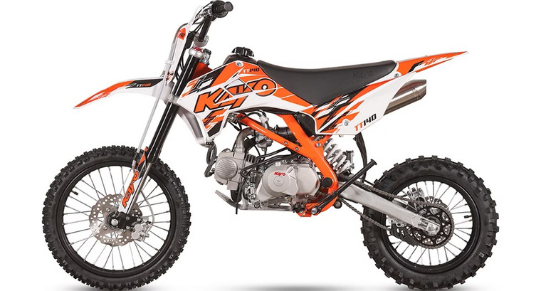 The image showcases the Kayo TT140 140cc Pit Bike, a high-performance off-road machine designed for riders who demand power and precision. The bike features a sleek and aggressive design with a 33.6-inch seat height, making it suitable for taller riders. The 140cc 4-stroke engine and electric/kick start system are highlighted, emphasizing the bike's power and ease of use. The inverted front forks and single rear shock are prominently displayed, showcasing the bike's advanced suspension system. The front and rear disc brakes are visible, highlighting the bike's safety features. The 17-inch front tire and 14-inch rear tire provide excellent traction and stability, while the low tack seat cover adds comfort and grip. The 11.4-inch ground clearance allows the bike to tackle rough terrains with ease. Overall, the image captures the essence of a powerful, high-performing, and versatile pit bike ready for any off-road adventure.