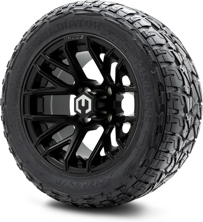 The image showcases a set of four MODZ® Matrix Matte Black 12" Golf Cart Wheels paired with X-Comp Gladiator (215/50-R12) DOT Steel-Belted Radial Tires. The wheels feature a sleek matte black finish with a modern, rugged design, complemented by black lug nuts and center caps. The tires are robust and treaded, designed for both street and turf use. The combo is professionally mounted and balanced, ready to enhance the performance and appearance of any lifted golf cart.