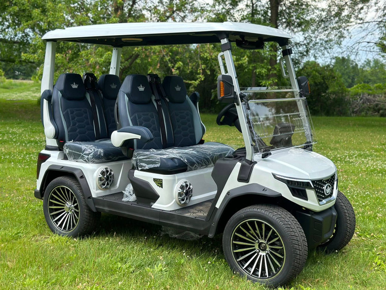 Evolution D-MAX GT4 luxury electric golf cart with forward-facing design, black automotive-grade seats, 10.1-inch touchscreen with CarPlay, 24-speaker audio system, LED lighting, and aluminum wheels, built for performance and style.