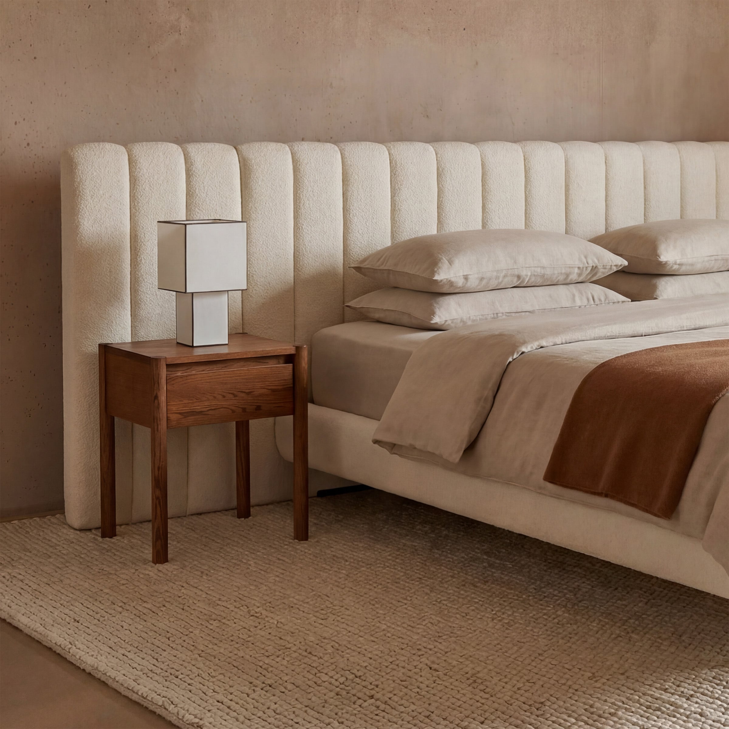 a bed with a lamp on the side