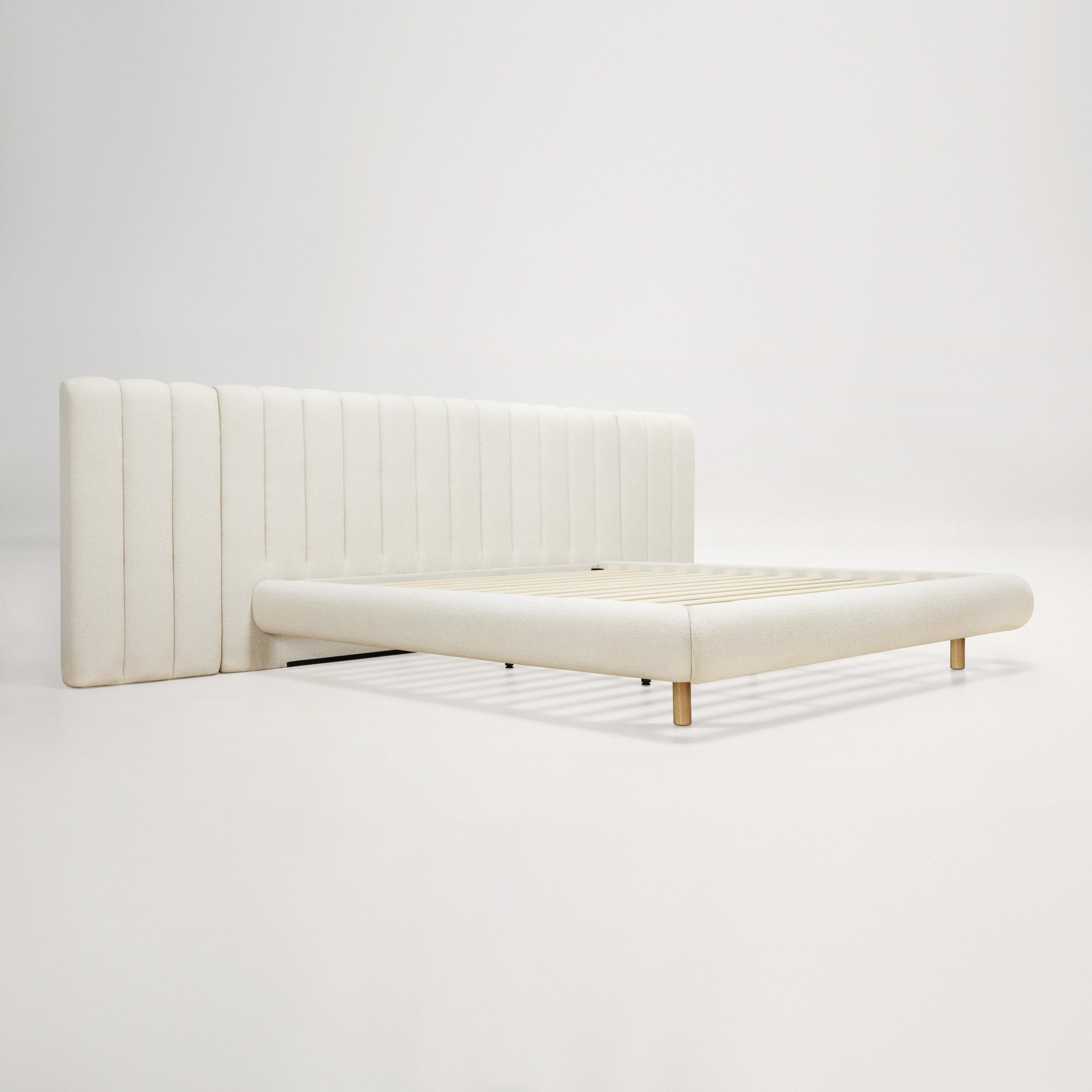 a white bed with a white cover