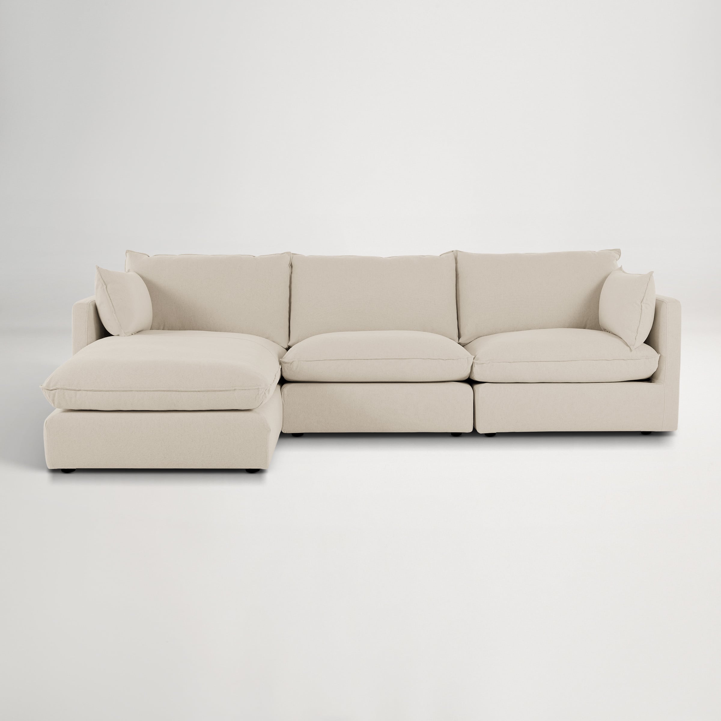 a white couch with a white cushion