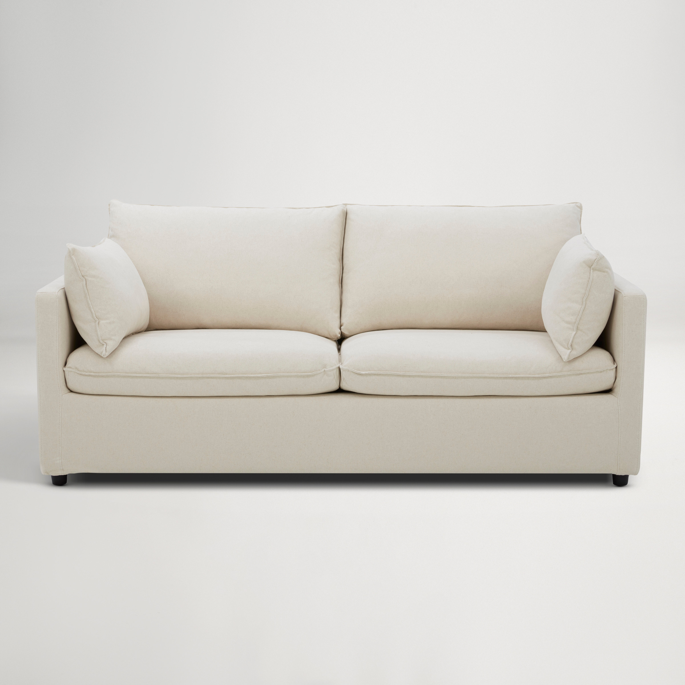 a white couch with a cushion