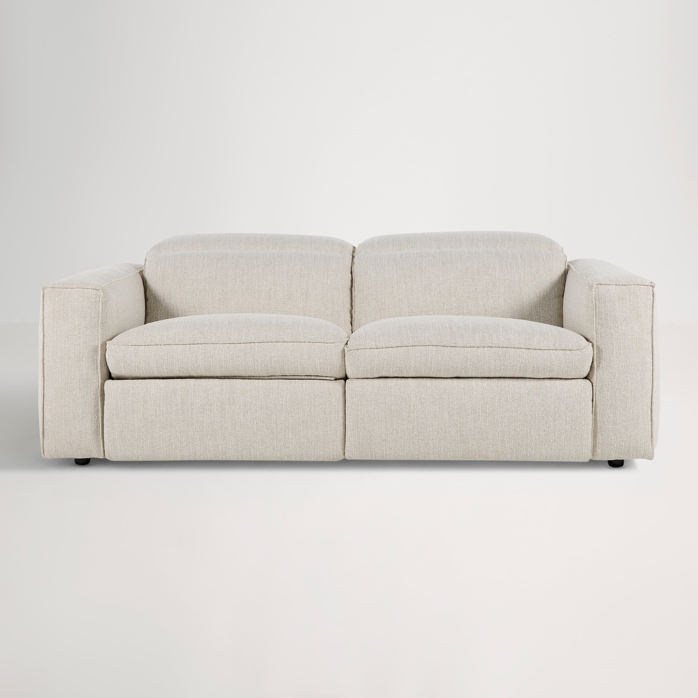 a white couch with a grey cushion