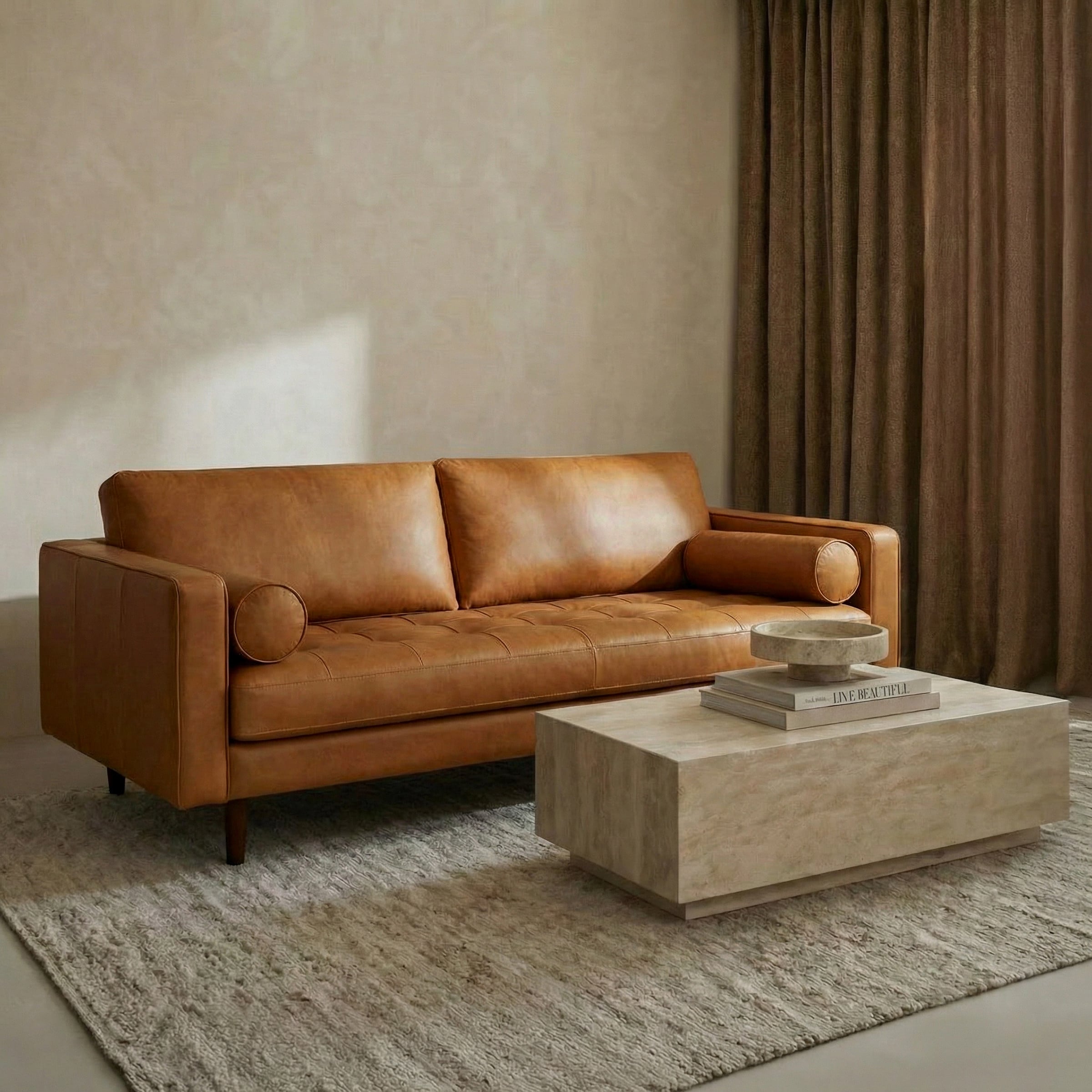 a brown couch with a coffee table and books on it