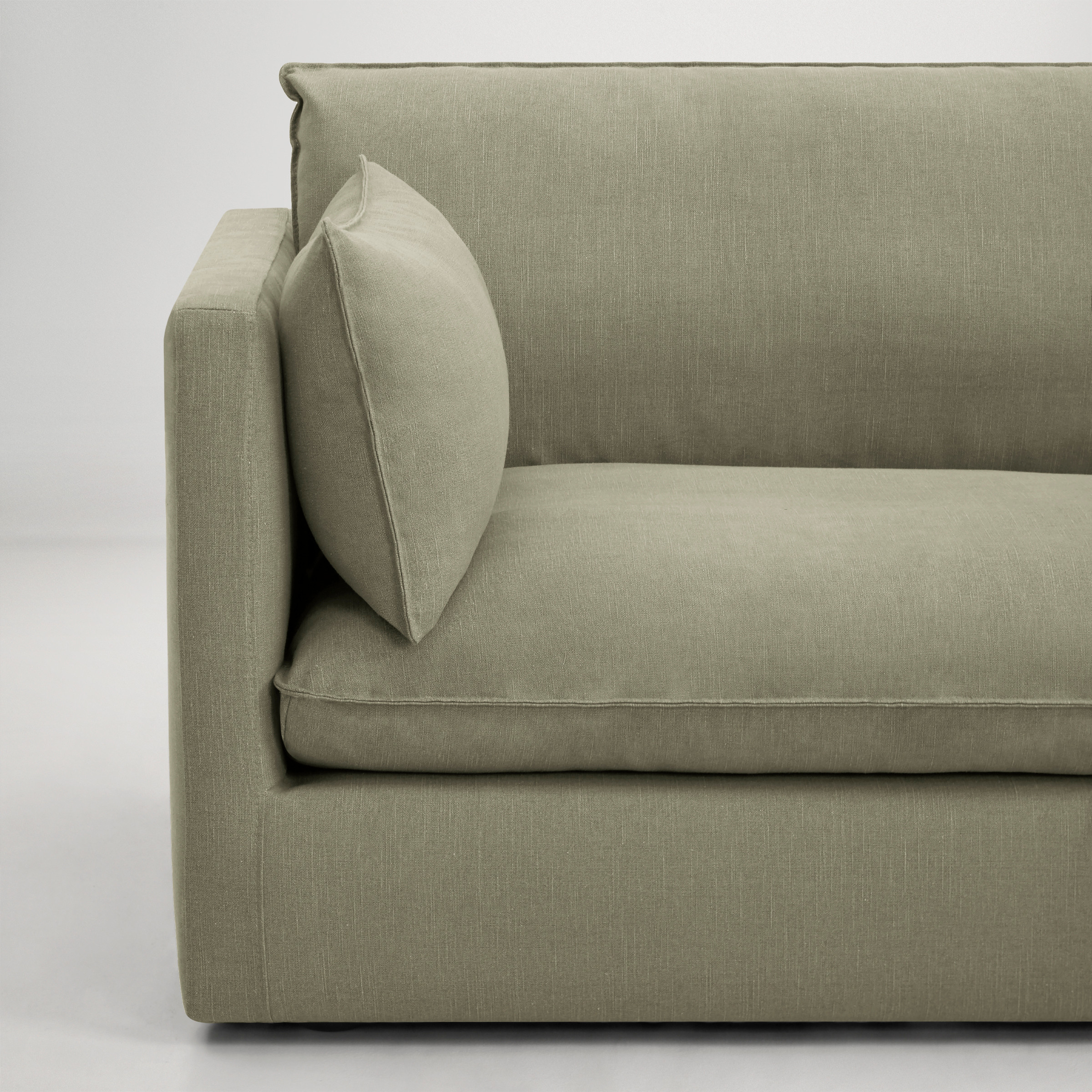 a grey couch with a grey cushion