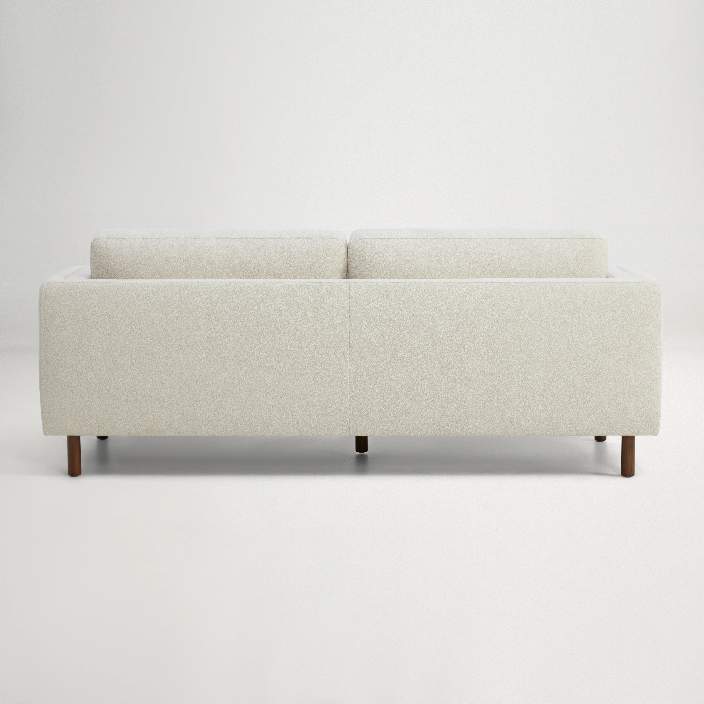 a white couch with a cushion